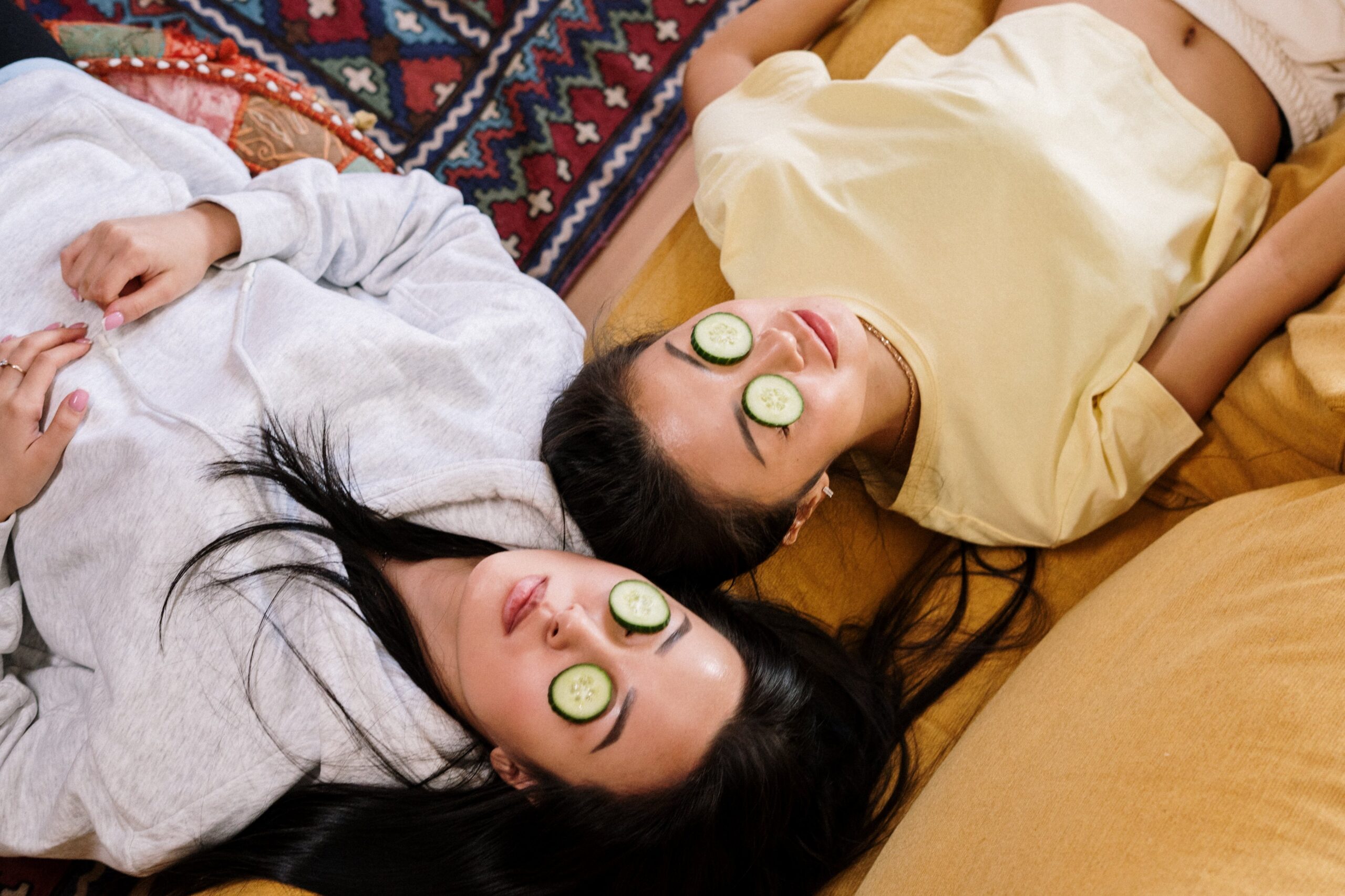 Two girls doing home treatment for dark circles and puffy eyes