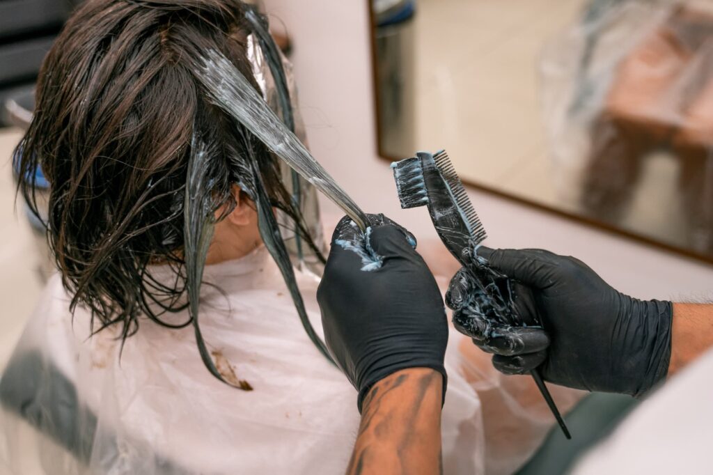 Girl bleaching her hair with Least Damaging Hair Bleach Brands