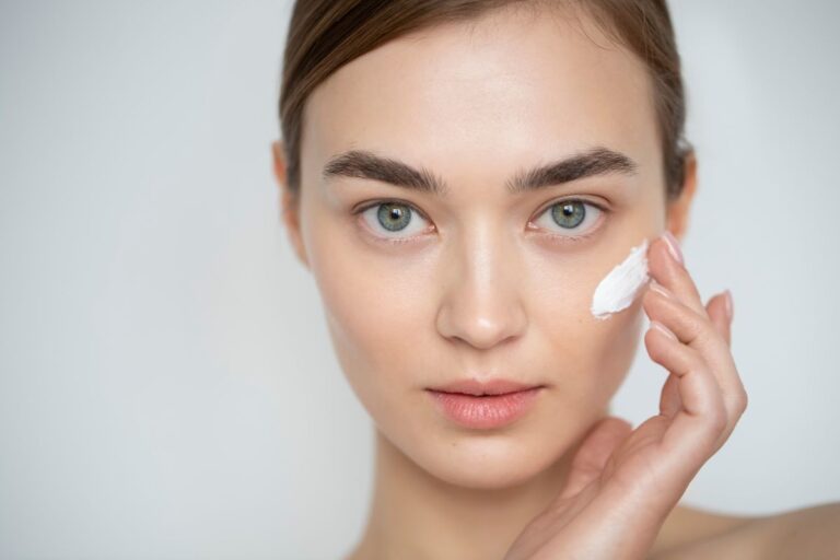 portrait-beautiful-woman-with-clear-skin-using-moisturizer-her-face